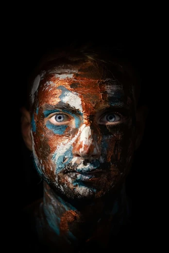 the face of a person with blue paint on his body