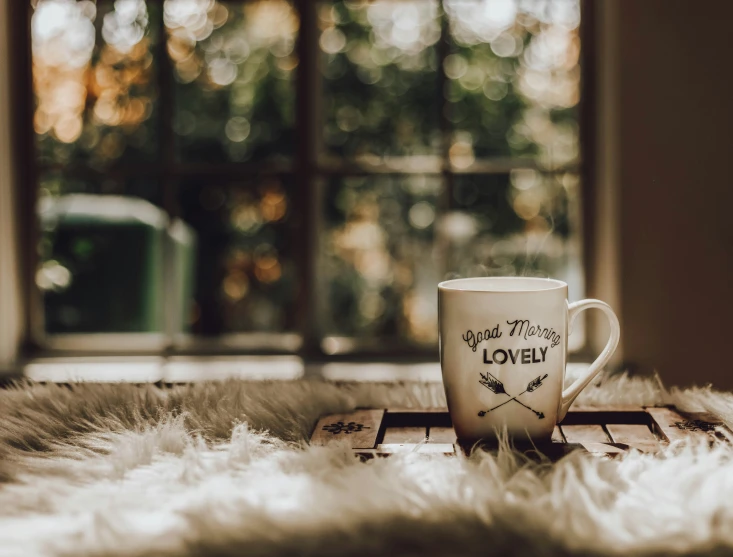 a coffee cup sitting on top of a wooden table