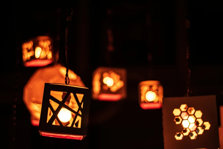 an array of lit up lanterns in the dark