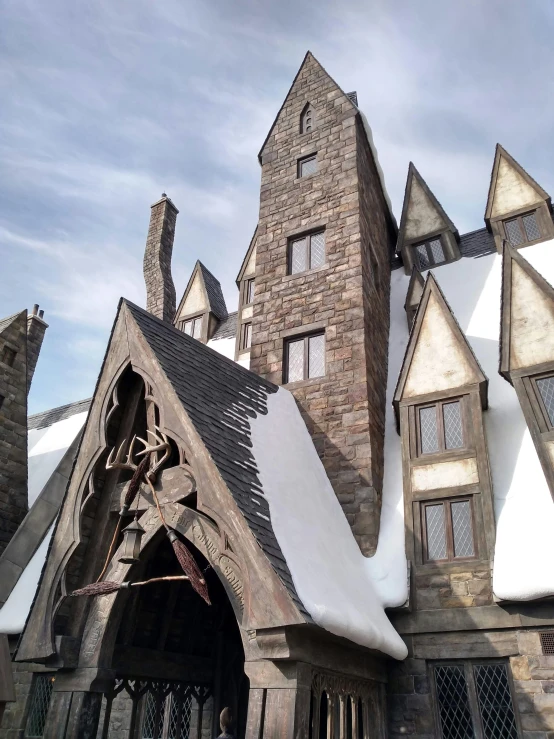 a building has a large roof with two chimneys and windows