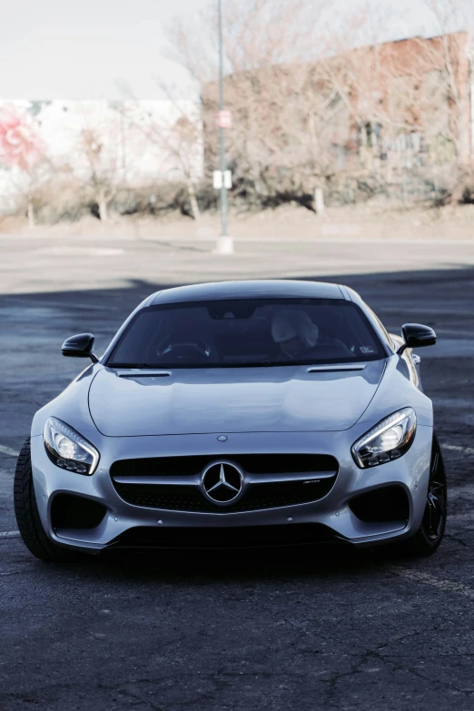 mercedes - amg gt4 coupe in silver parked on concrete