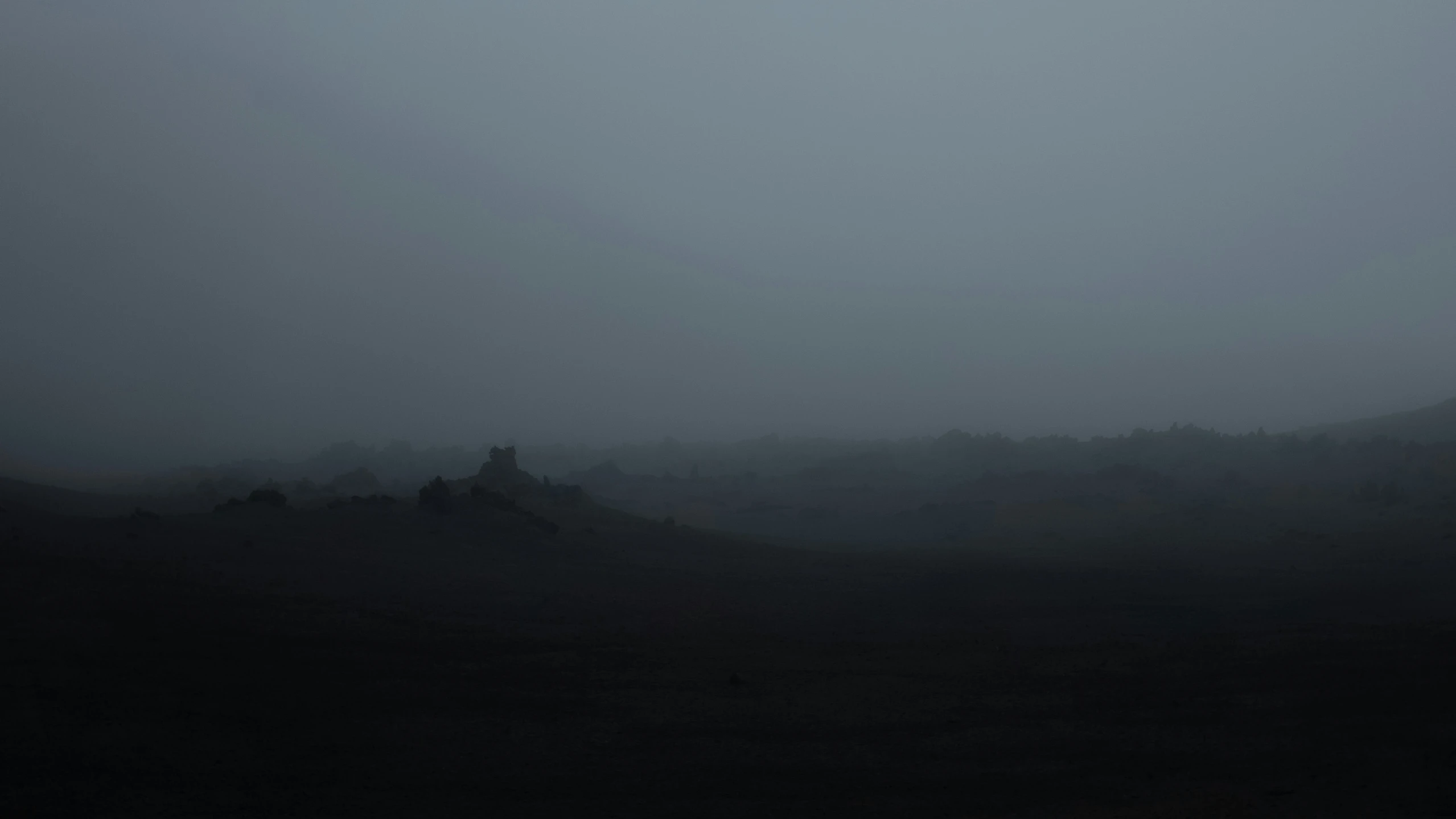 a lone sheep is seen in the dark hills