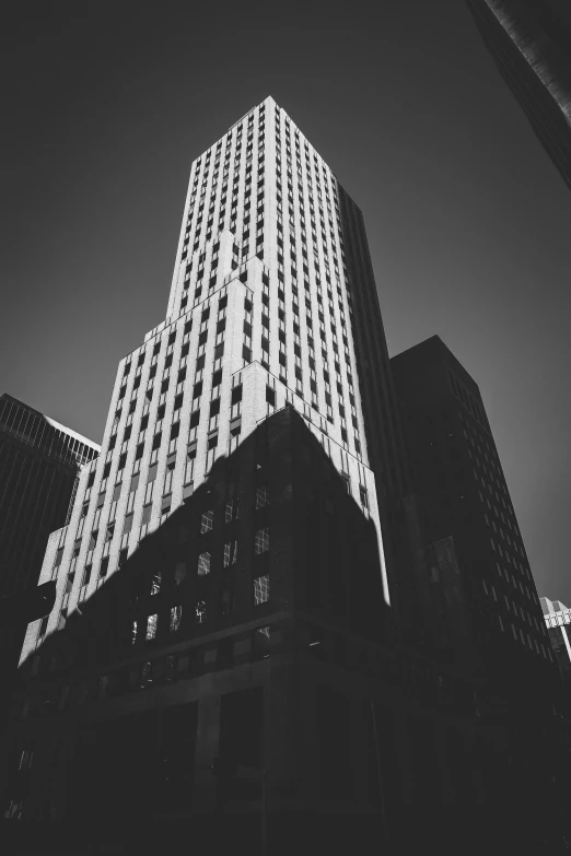 the top of two skyscrs against a black and white sky