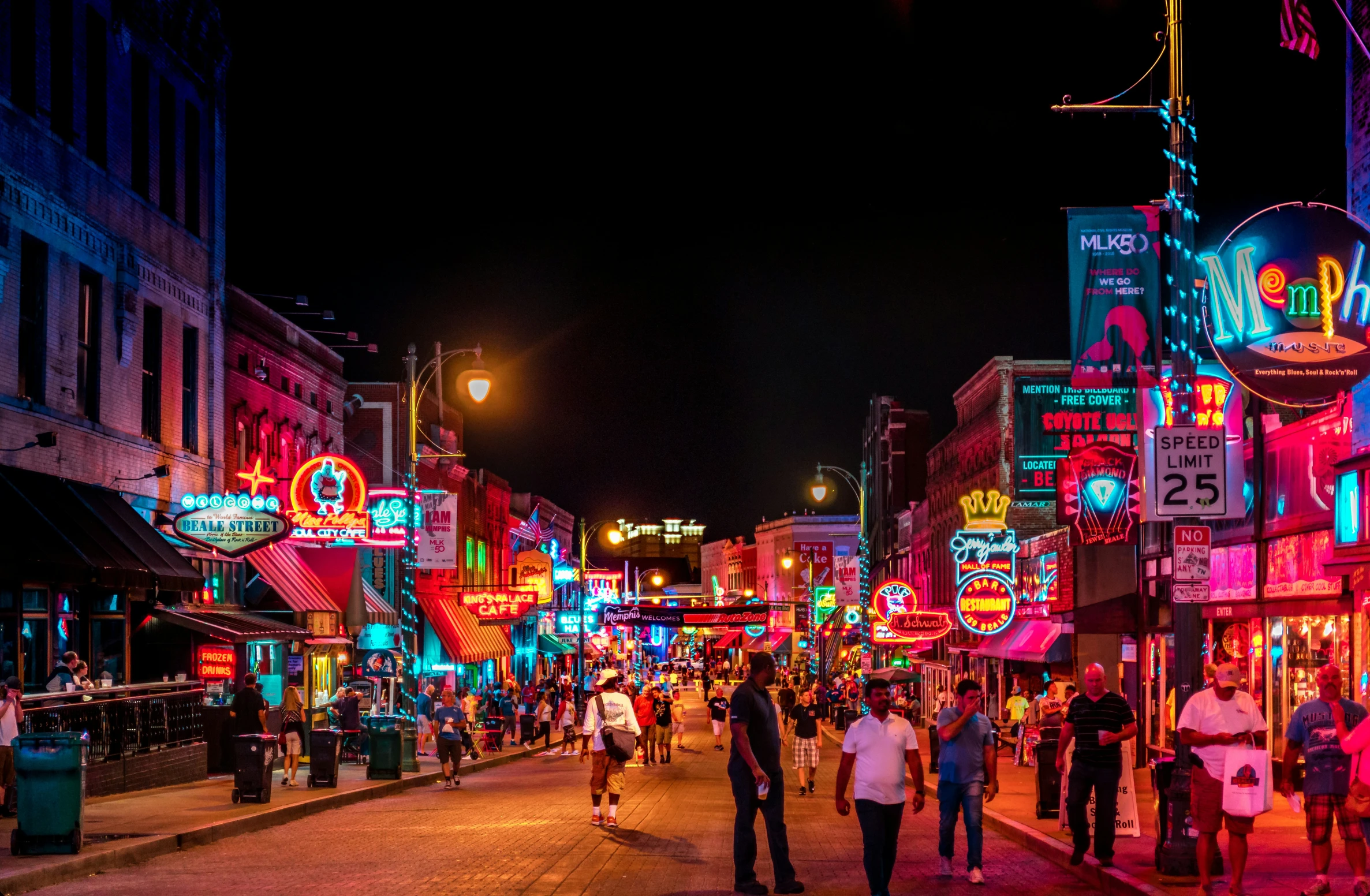 neon lights illuminate the busy street at night