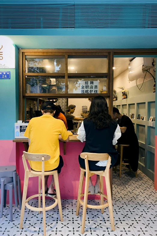 two people sitting at a table eating food