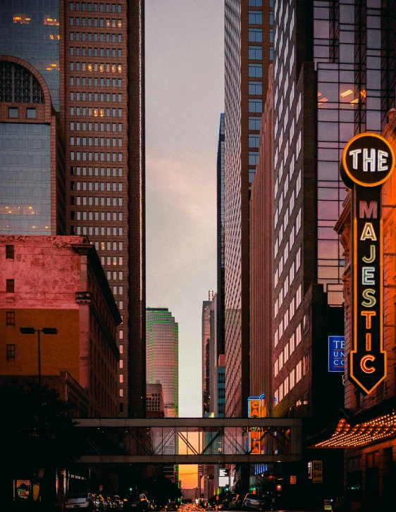 an orange sign hanging off the side of a building