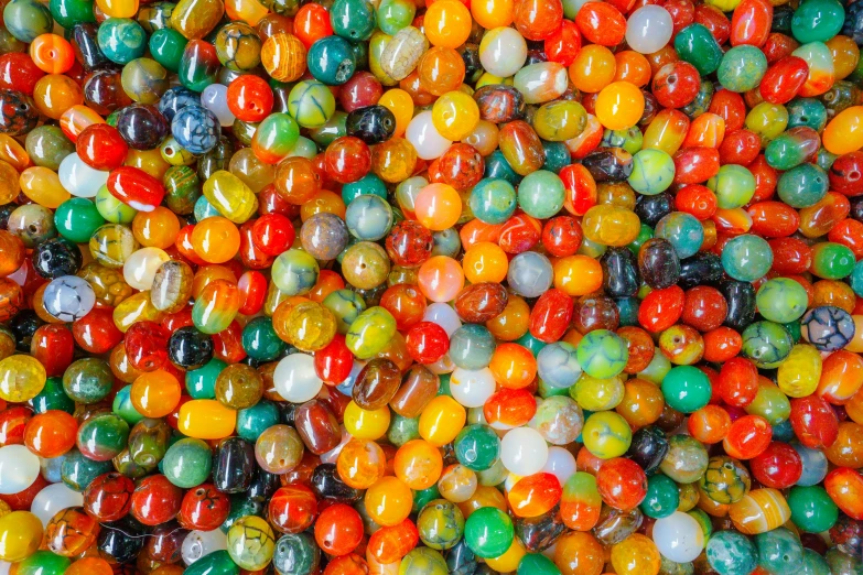 many different colored balls together on the ground