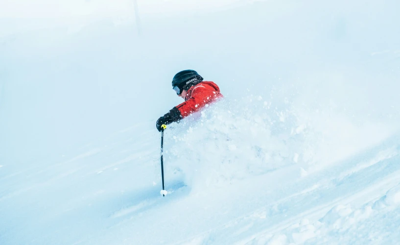 a man is in the snow wearing skis