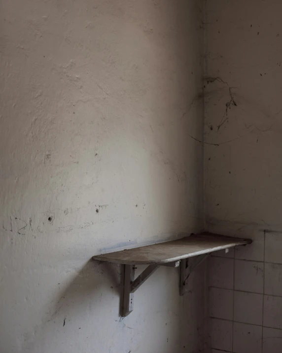 an old run down bathroom with some shelves