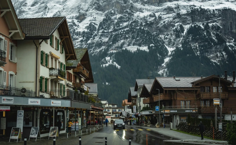 a village in the mountains with some snow on it