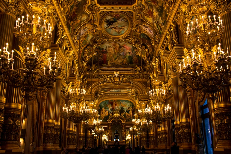 a beautiful building that has chandeliers and a large golden ceiling
