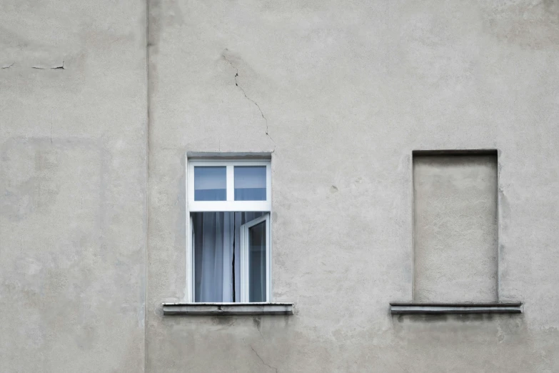 a large white window sitting next to a wall