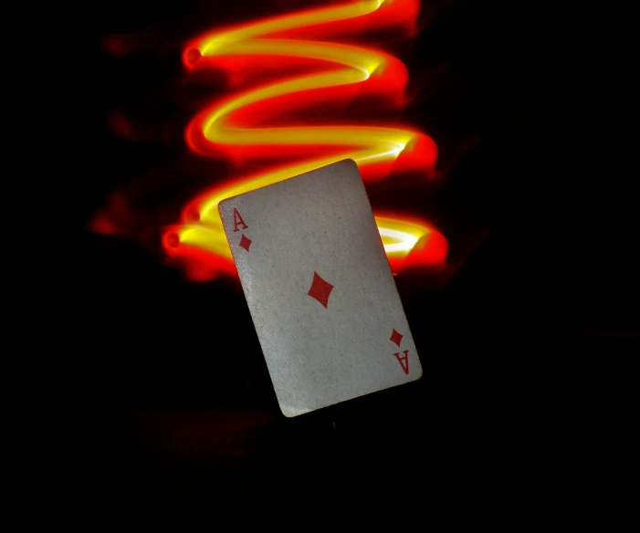 an illuminated ace of card in the middle of a table