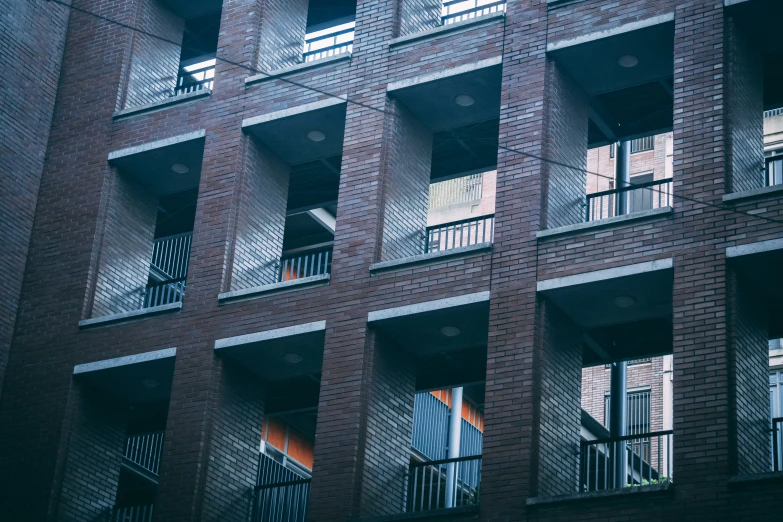 an apartment building with windows covered in red brick