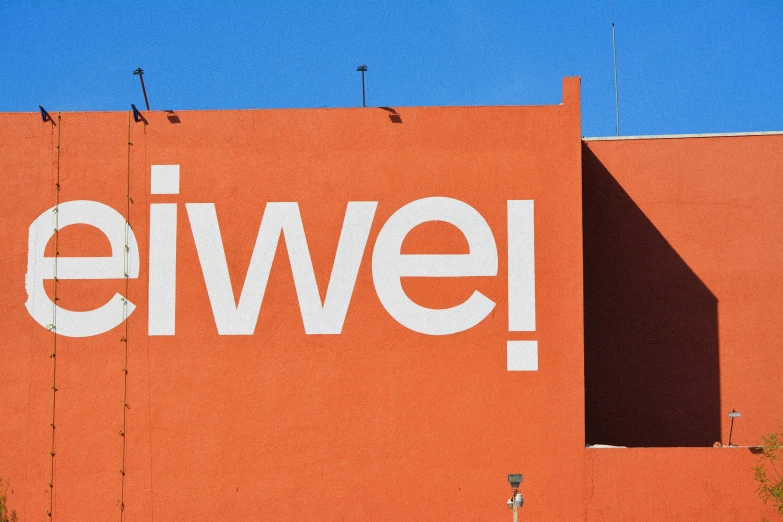 an orange building with the word ewel painted on it