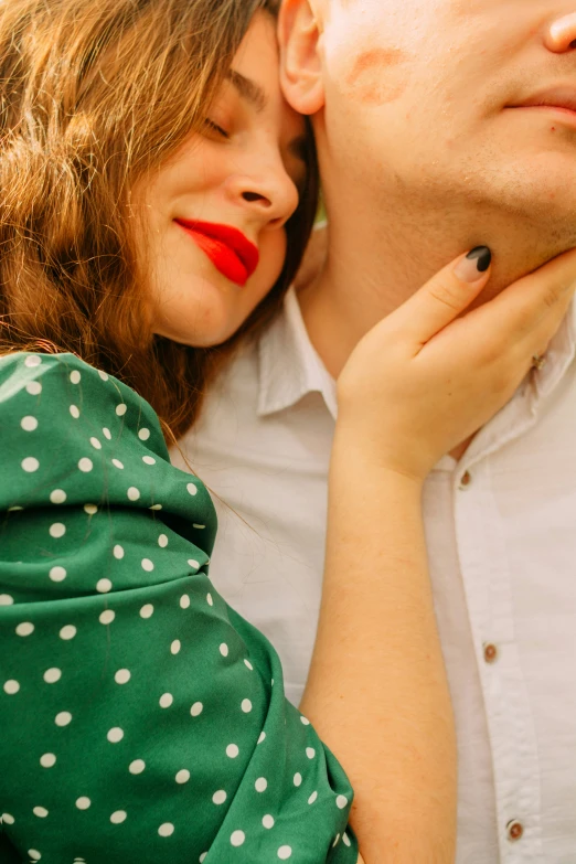 an attractive woman kissing the cheek of a man