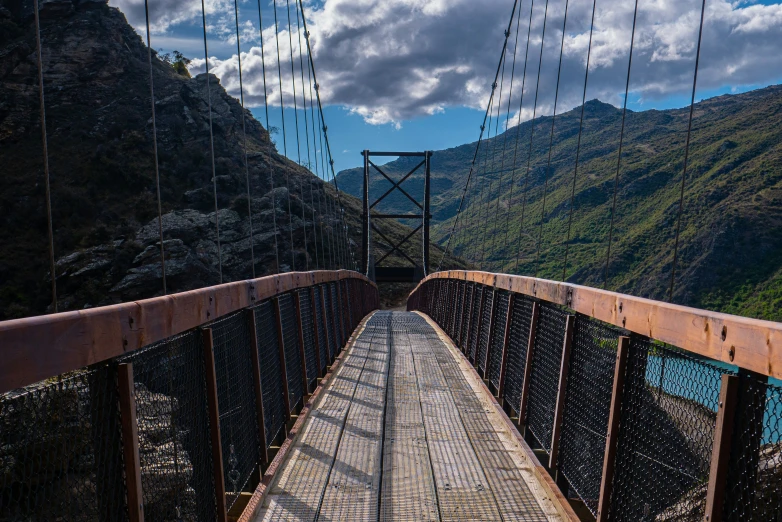 an aerial view of a suspension bridge over water