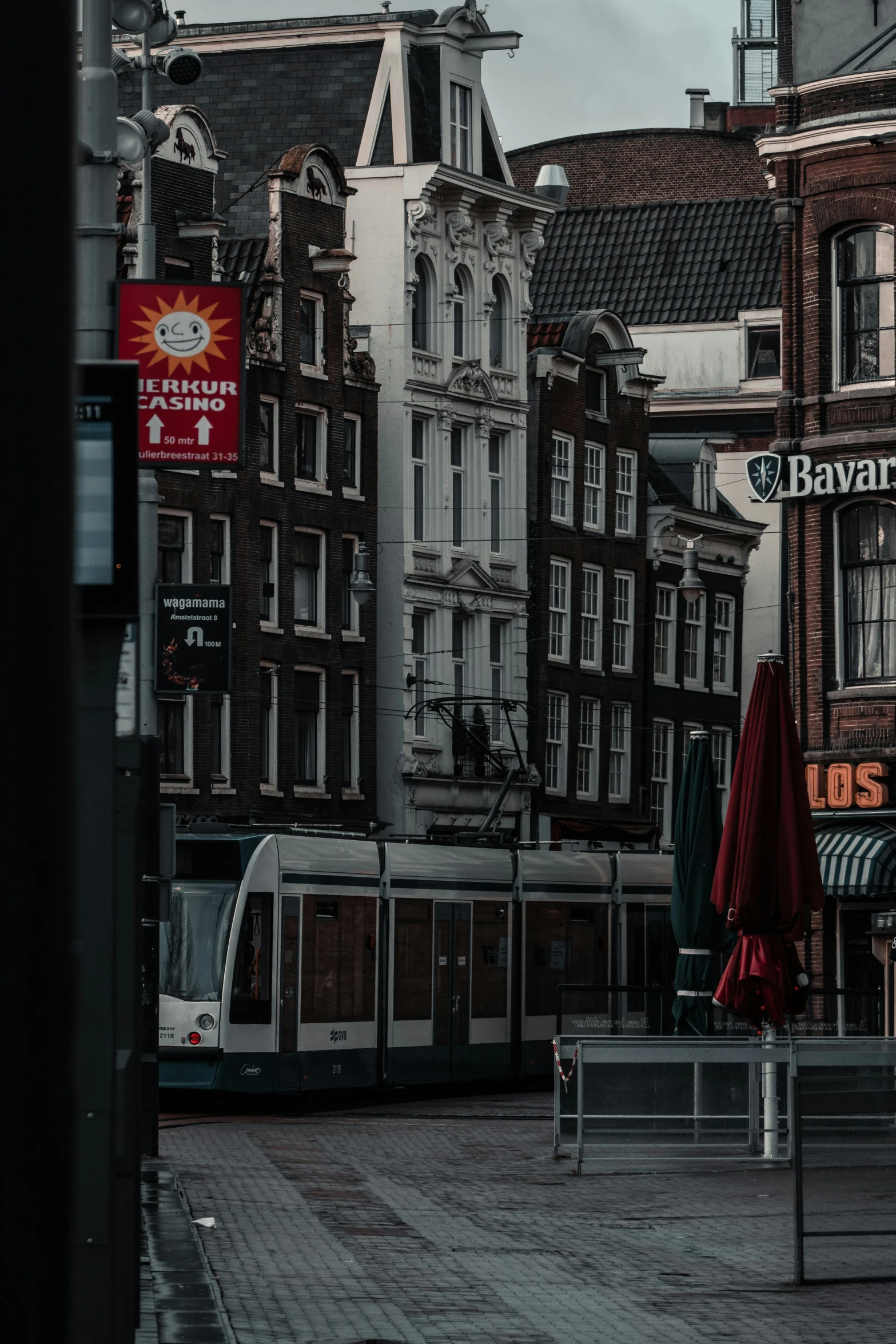 a train parked on the street with several buildings in the background