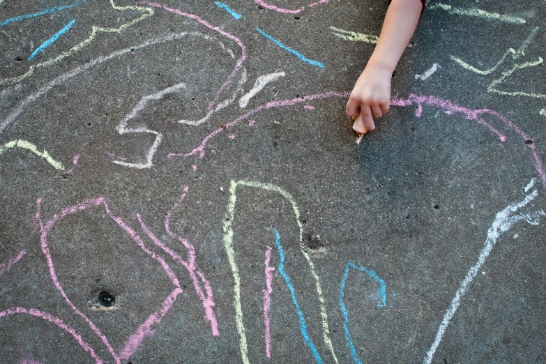 there is a childs hand drawn on pavement