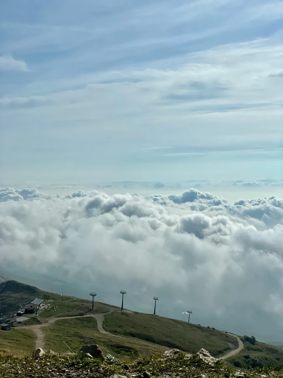 a hill that has a bunch of clouds on it