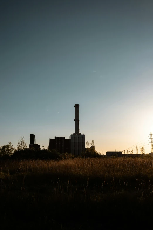 a factory with a sky background and buildings