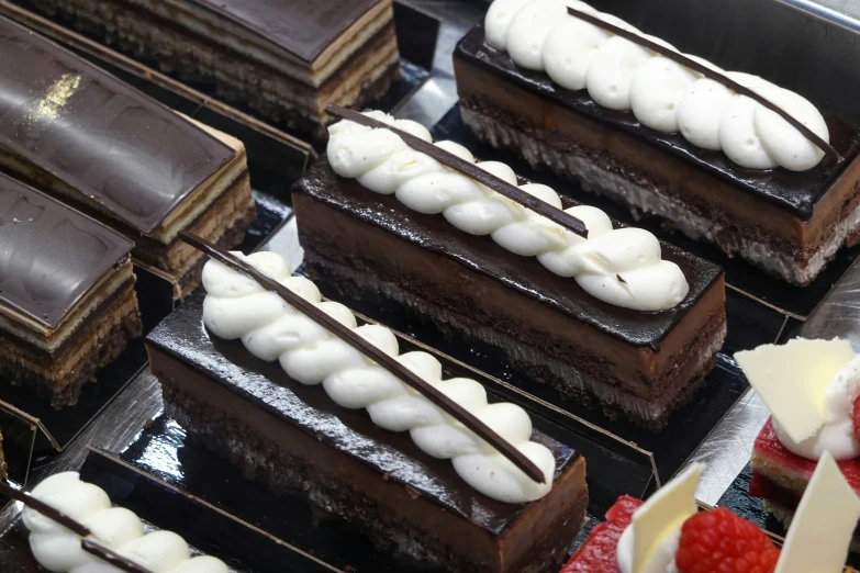 chocolate brownies and raspberries in a display case