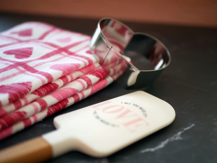 an ironed cookie cutter, napkin and tea towels on a black surface