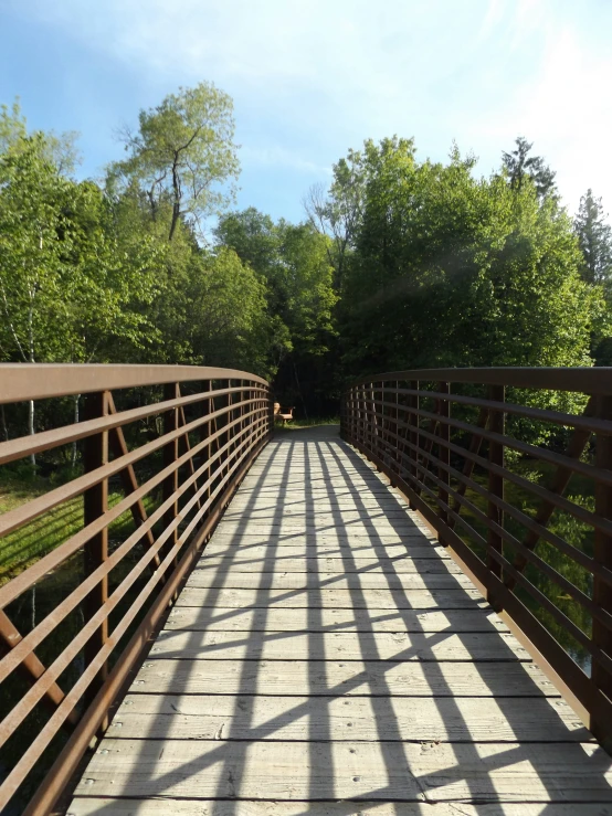 the long wooden bridge is over which the sun shines