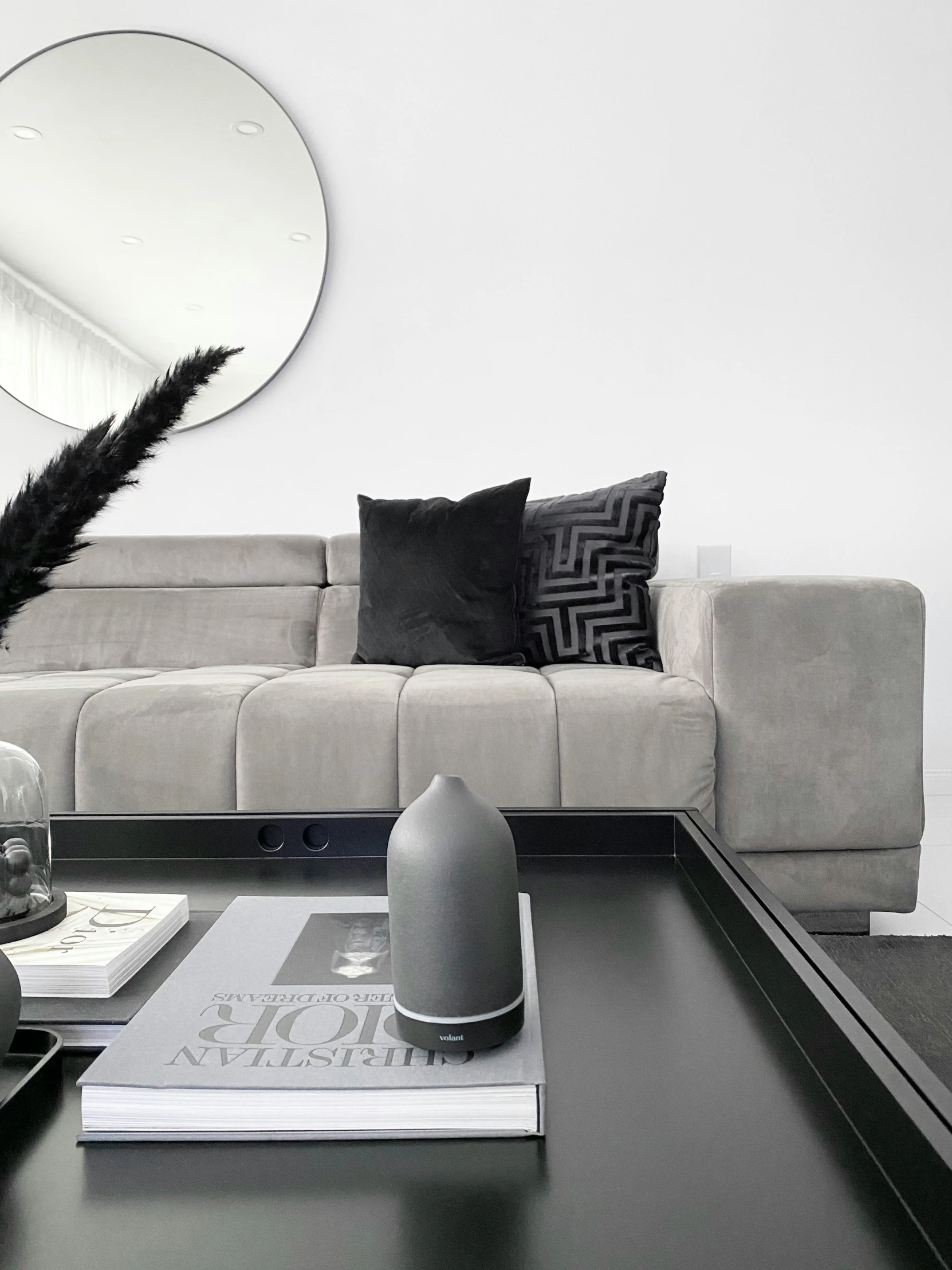 a living room with a large gray sectional sofa and table