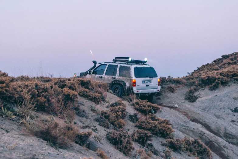 a white van parked on top of a hill