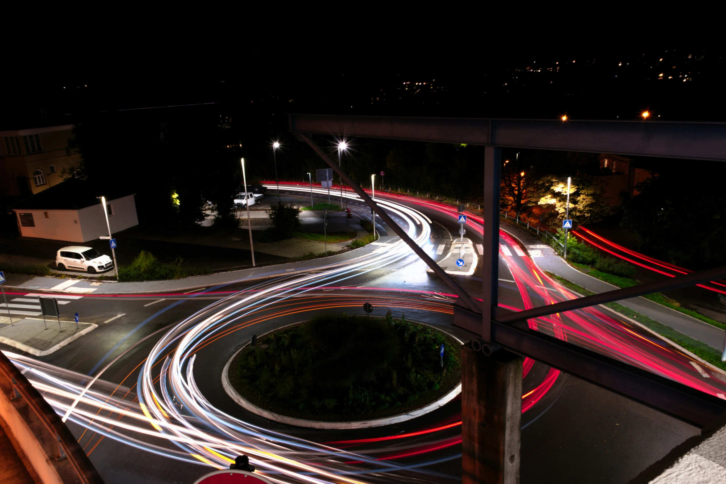 multiple cars drive on the freeway at night