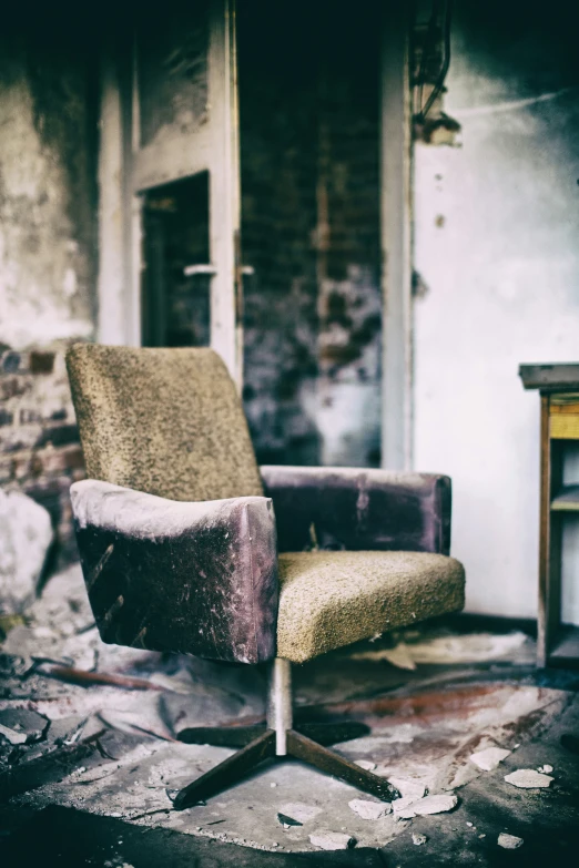 a brown chair on an old room floor