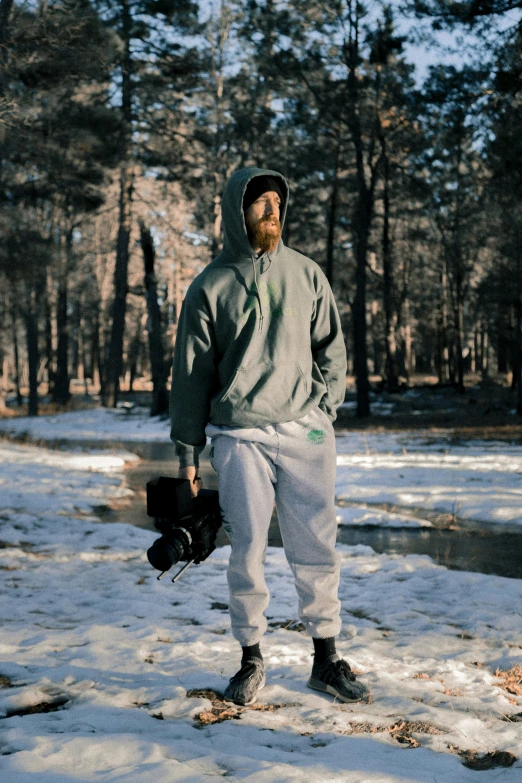 a man standing in the snow with a baseball glove