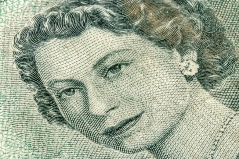 a close up of the face of queen victoria on the british five pound note