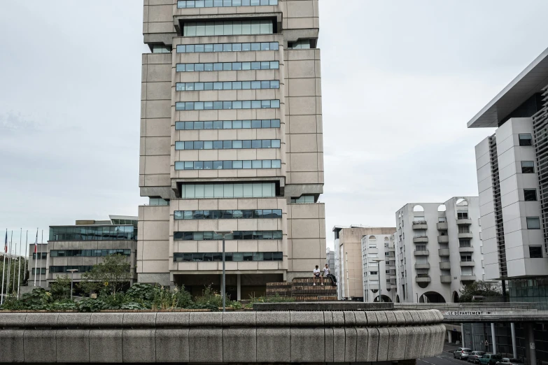 two buildings next to each other in front of a cloudy sky