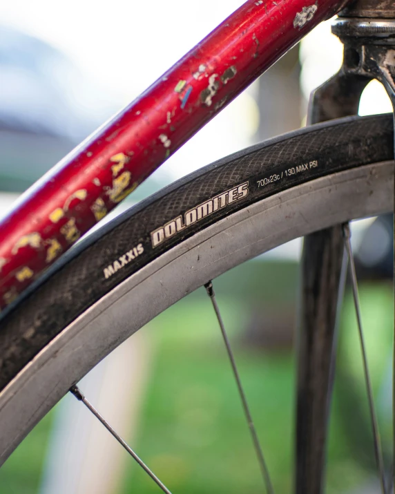 a red bicycle with the numbers 2 / 5 is parked