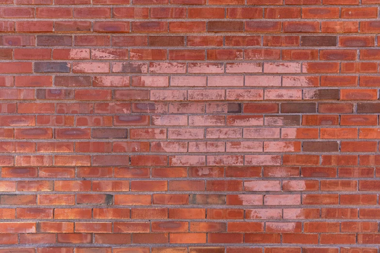 a red brick wall with a broken heart painted on it