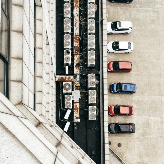 a parking lot filled with parked cars next to a building