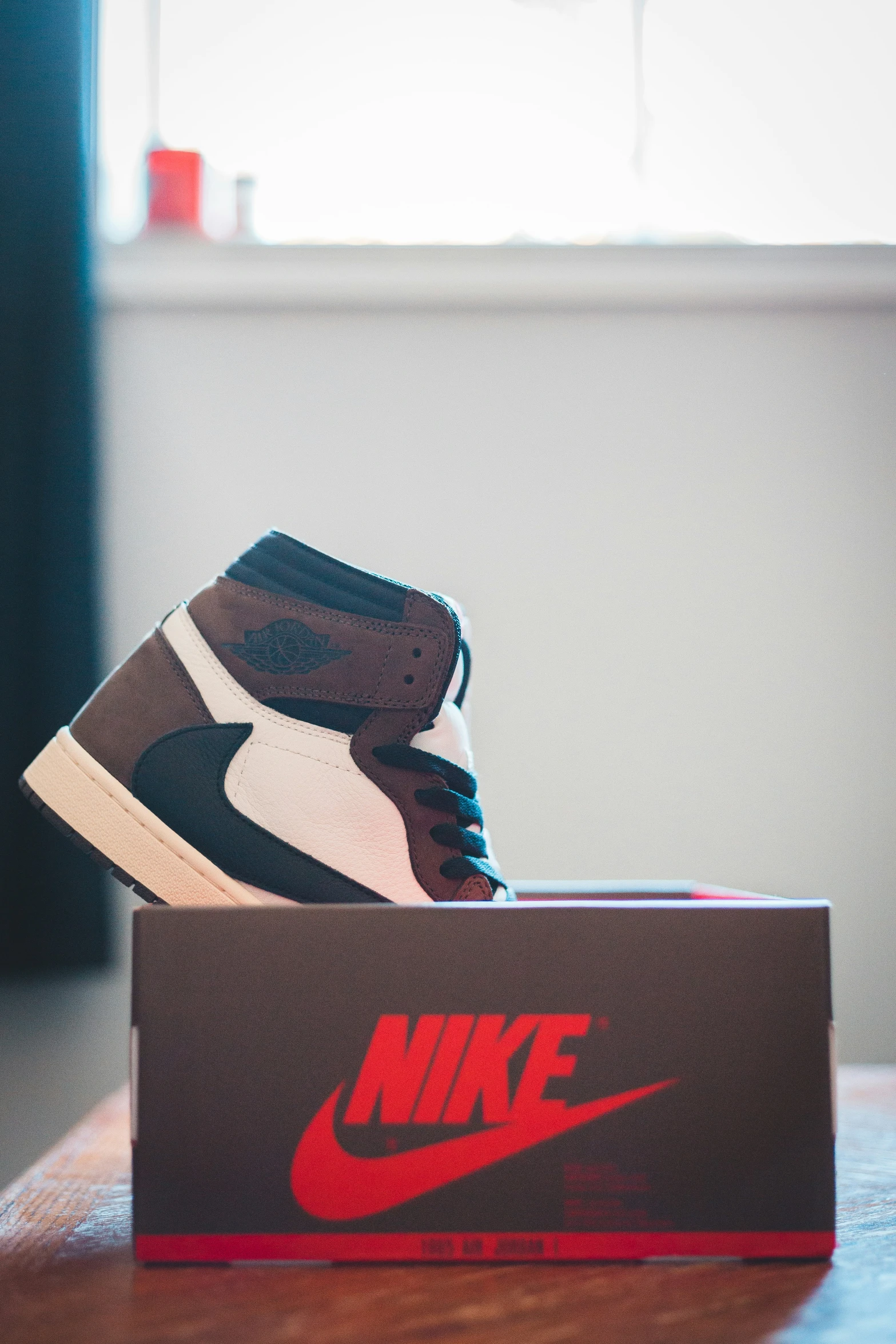 a close up view of a shoe box sitting on a wooden surface