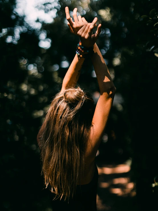 a girl holding her hands in the air