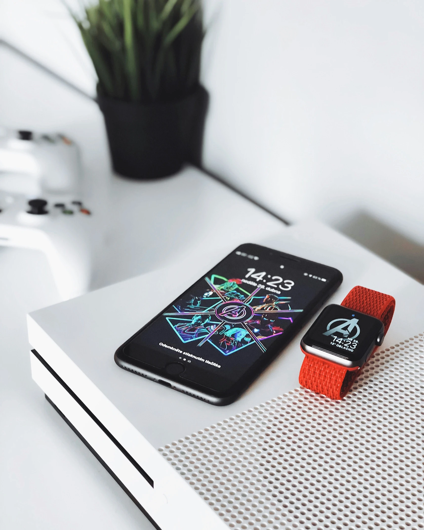 two smart phones sit side by side on a shelf