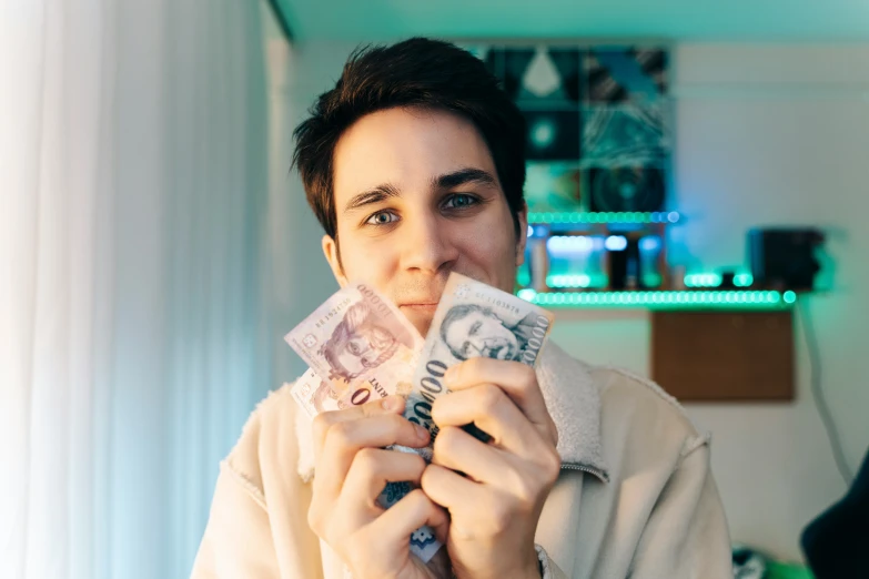 a woman with dark hair is holding two different notes