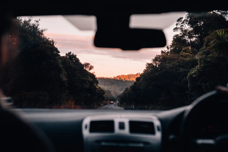 a person driving on a vehicle with a mountain in the background