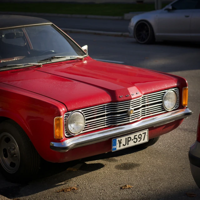 a red classic car with the hood and flat hood