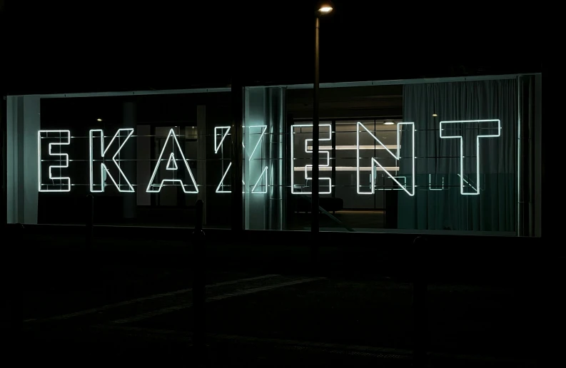 a large illuminated sign sitting inside of a building