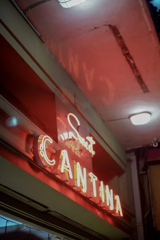 a neon sign hanging from the side of a restaurant