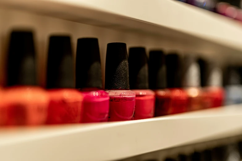 many different colors of nail polish in an array