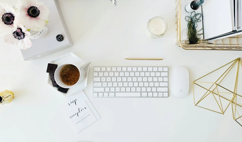 white desk top with keyboard and mouse on it