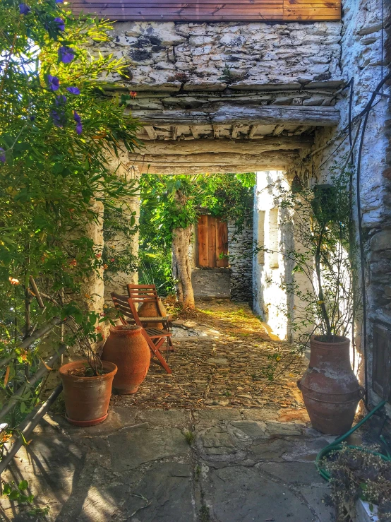 a door way with pots and chairs in an old house