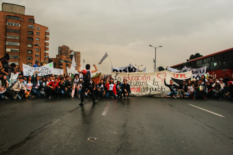 a group of protesters marching in the middle of a street